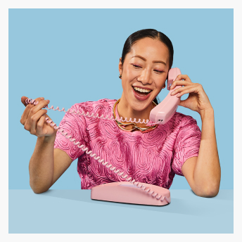 Woman laughing with Pink Phone