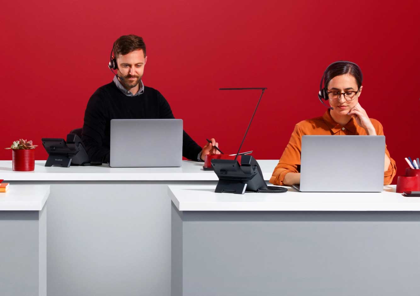 Uunique and adaptable enterprise solutions image-Two workers working on desk