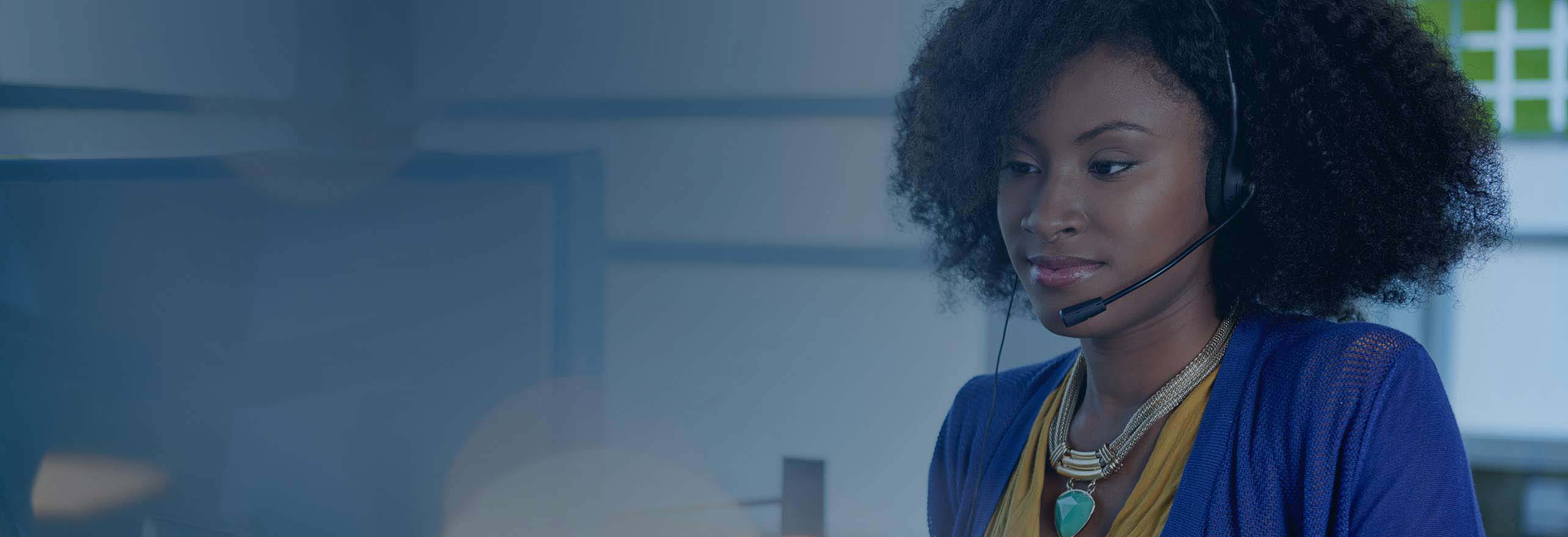 African American woman working using a inbound call center platform wearing a headset