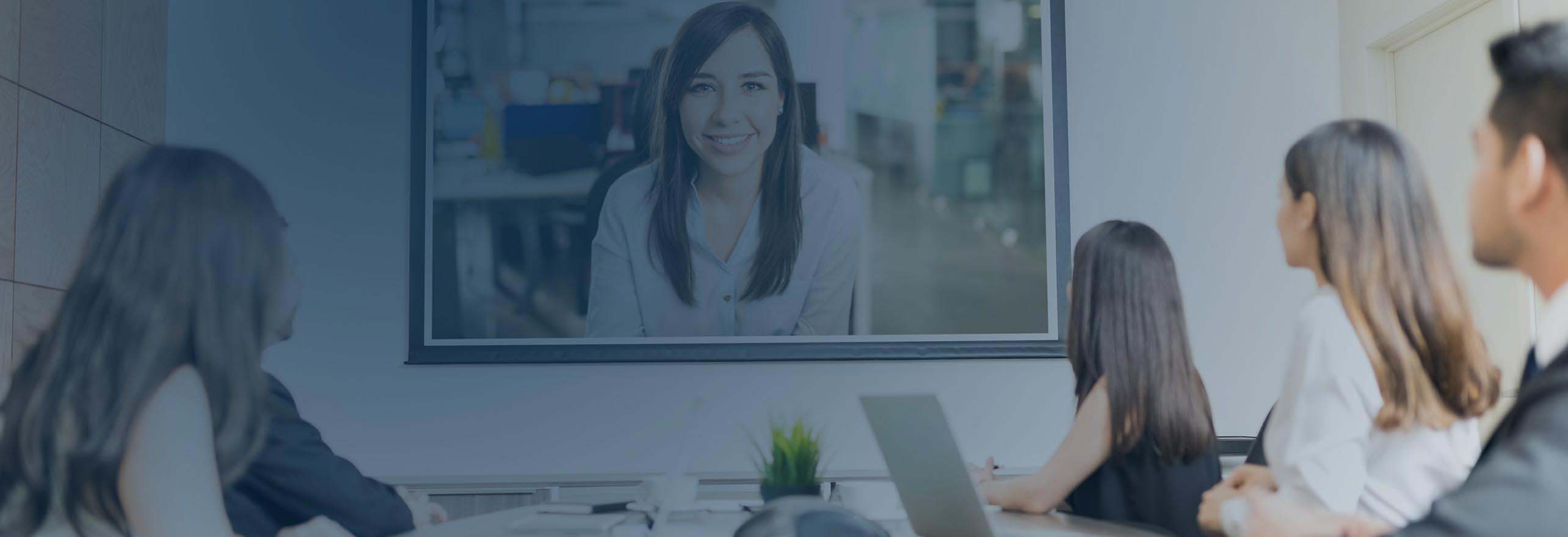 Enterprise business employees in a boardroom having a video conference